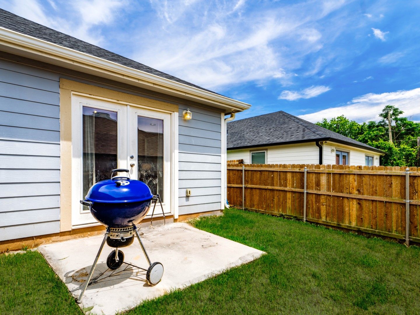 Fenced backyard with grill