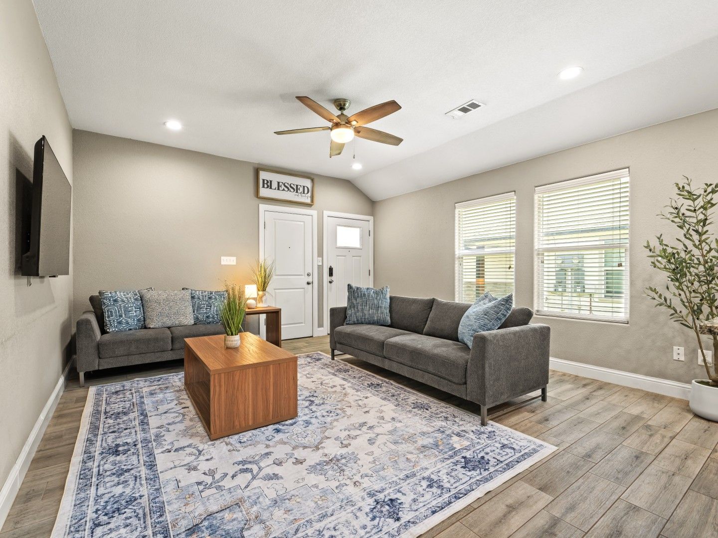 Open living room with sectional sofa and TV