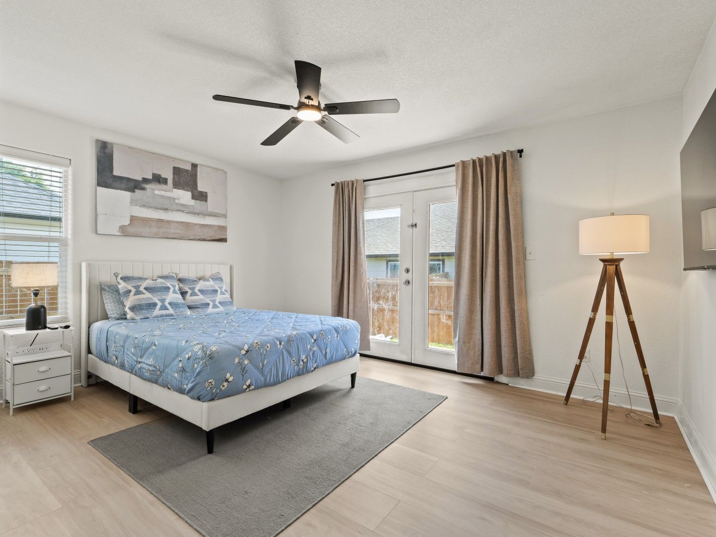 Master suite bedroom with queen bed and private patio doors